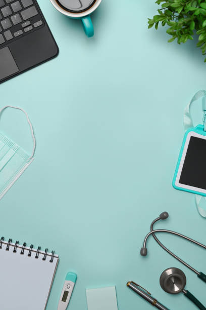 istock Top view doctor workspace with laptop computer, stethoscope, notebook and coffee cup. 1325841643