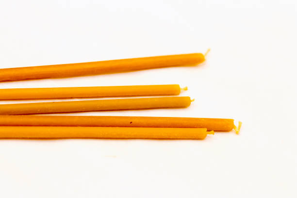 istock Some church candles laying isolated on the white background 1325841679