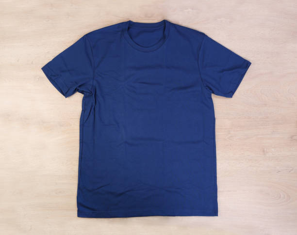 istock Front navy blue tshirt wooden background 1325841754