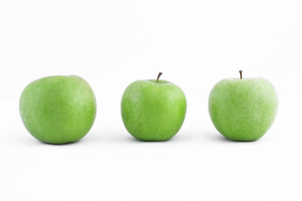 istock Three ripe healthy green apples on a white background 1325841925