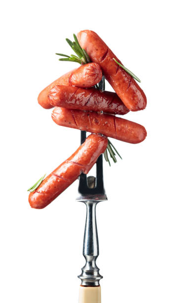 Small grilled sausages with rosemary on a fork.