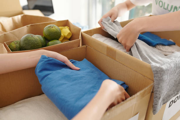 istock People Packing Clothes and Fresh Food 1325845004
