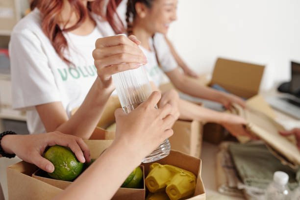 istock Volunteers Putting Groceries in Cardboard Boxes 1325845014