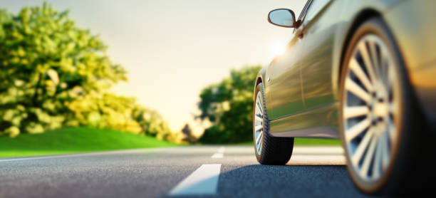 Car on sunny road Car drives on a  sunny road with green landscape scenery - 3D illustration driving stock pictures, royalty-free photos & images