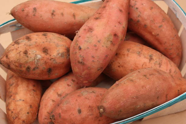 istock Sweet potatoes on a market stall 1325850022