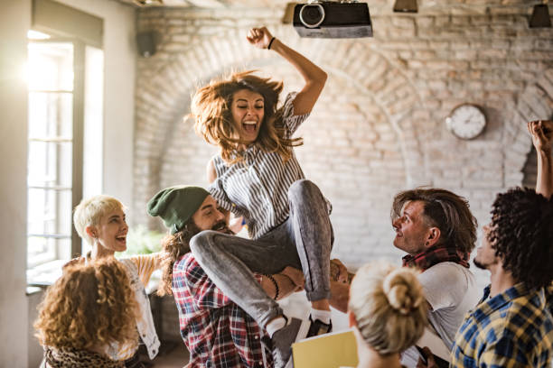 istock Cheerful freelancers having fun while celebrating their success at casual office. 1325852305
