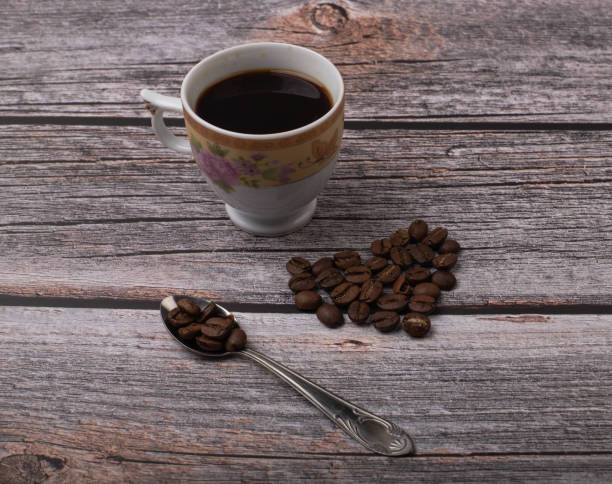 istock dark coffee and grains on wooden background 1325852321