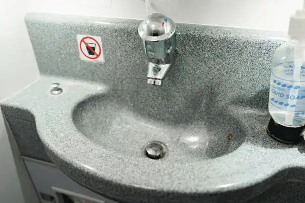 Photo of Passanger airplane toilet handwash sink close up