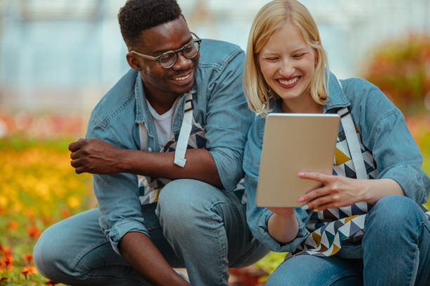 istock Two florists using digital tablet in a greenhouse 1325852427