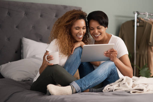 istock Shot of a couple using a tablet while sitting on the bed at home 1325852502