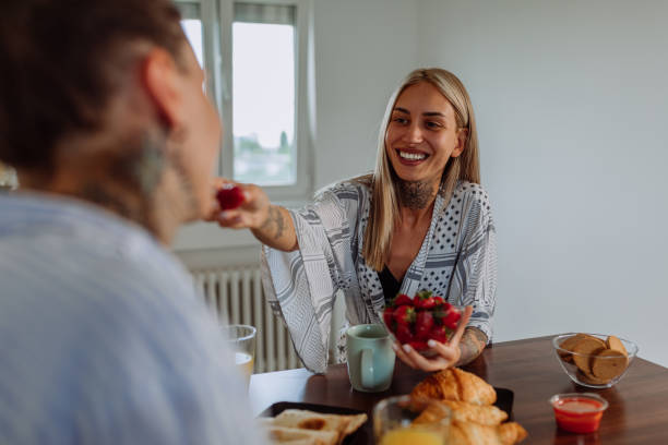 istock Young woman feeding her girlfriend at breakfast 1325852710