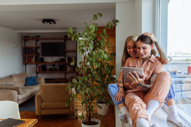istock Female couple spending weekend at home and using technology 1325852713