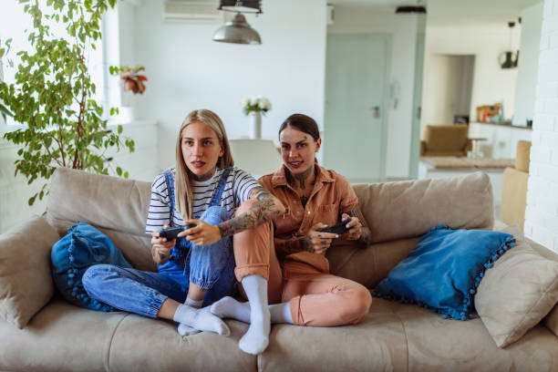 istock Female couple playing video games 1325852719