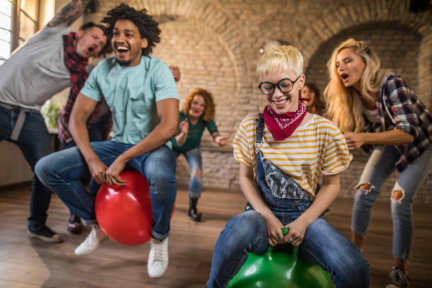 istock Cheerful colleagues having fun during space hopper at casual office. 1325852816