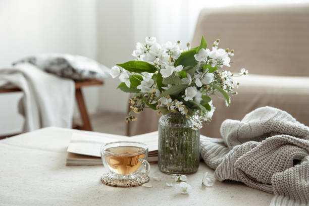 istock Cozy home composition with a cup of tea, a book and flowers. 1325853066