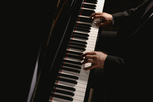 istock Man playing piano, above view. Talented musician 1325853848