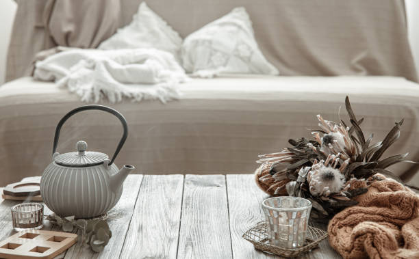 istock Teapot with tea and candles on the wooden table. 1325854006