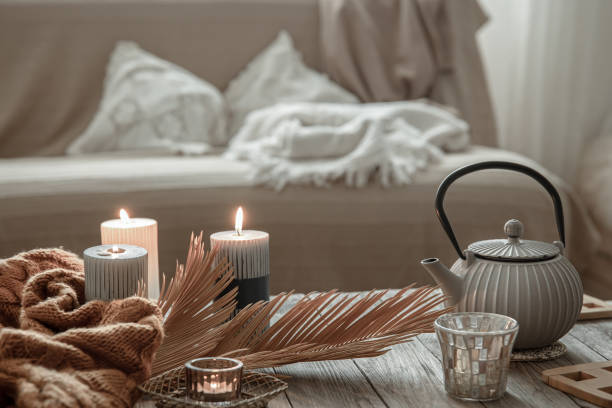 istock Cozy home composition with candles and a teapot. 1325854043