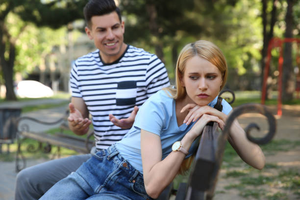 istock Young woman getting bored during first date with overtalkative man in park 1325854147