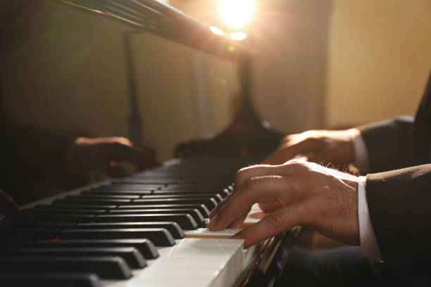 istock Man playing piano indoors, closeup. Talented musician 1325854196