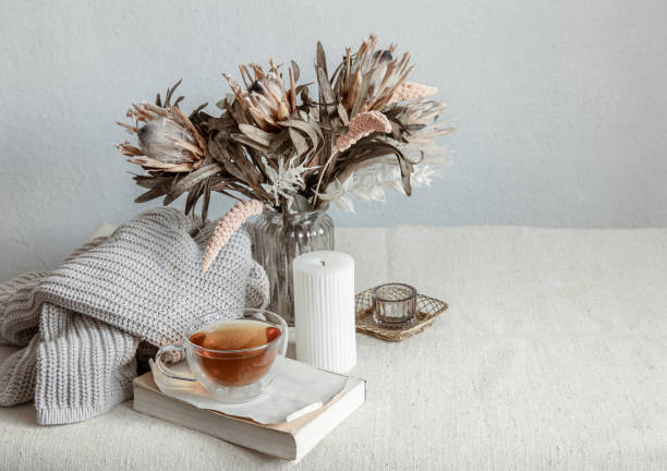 istock Cozy composition with tea, dried flowers and home decor details. 1325854216