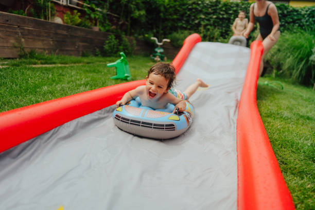 istock Water slide fun in our backyard 1325854439