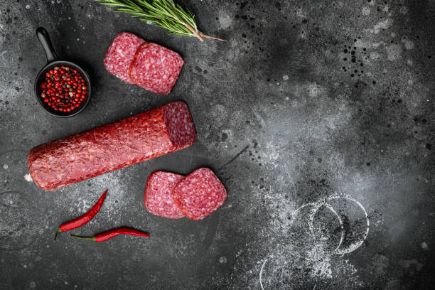 istock Salami with ingredients, on black dark stone table background, top view flat lay 1325854750