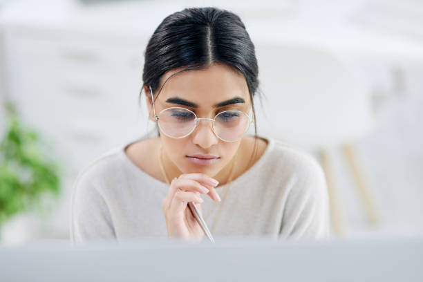 istock High angle shot of a young businesswoman looking thoughtful while working on a computer in an office 1325855522