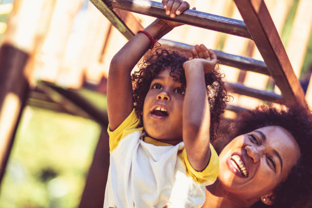 istock Mother and daughter on playground. 1325855813