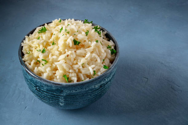 istock White rice in a bowl on a dark blue background 1325856114