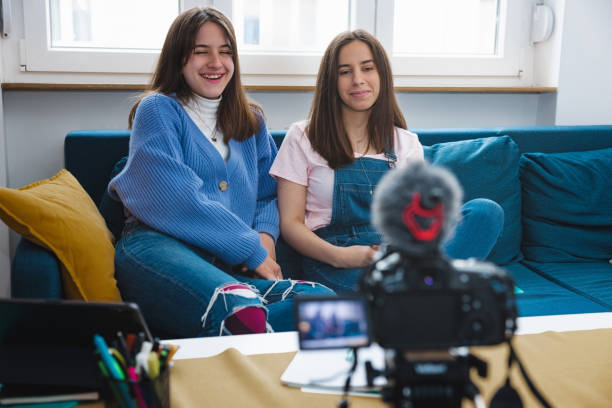 istock Two cheerful sisters filming a funny vlog 1325858267