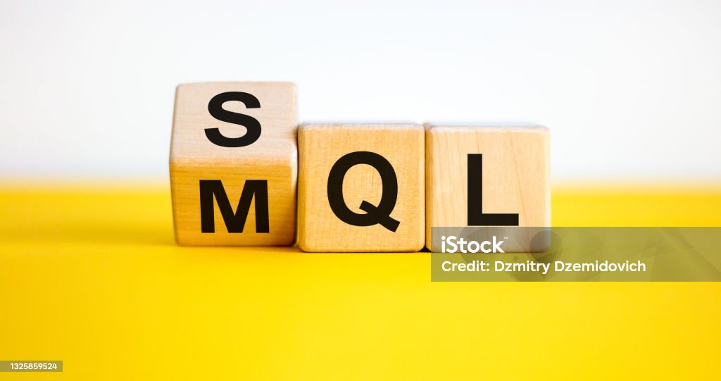 SQL or MQL symbol. Turned wooden cubes and changed words 'MQL marketing qualified lead' to 'SQL sales qualified lead'. Beautiful white background. Business and SQL or MQL concept. Copy space. Lead Stock Photo