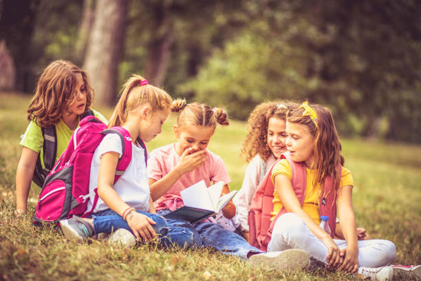 istock Large group of school kids having fun in nature. 1325863200