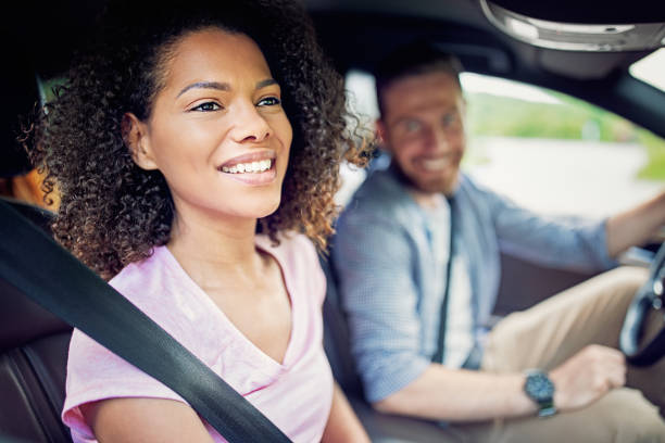 istock Couple driving a car and having fun 1325863747