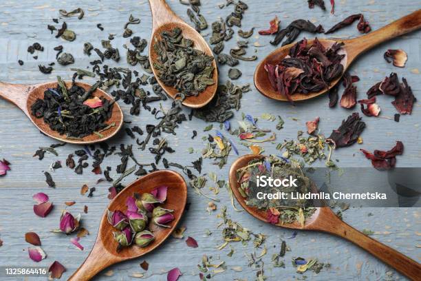 Flat Lay Composition With Different Teas And Spoons On Grey Wooden Table Stock Photo - Download Image Now