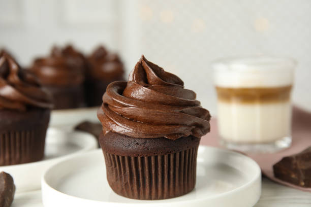 istock Plate with delicious chocolate cupcake on white table 1325864478