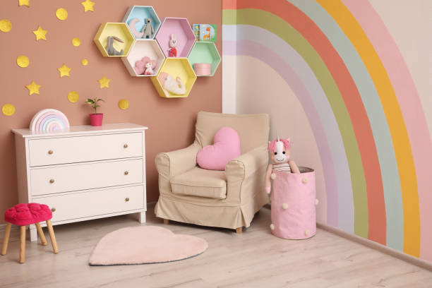 istock Cute child's room interior with beautiful rainbow painted on wall 1325864693
