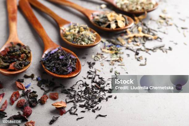 Composition With Different Teas And Spoons On Light Grey Stone Table Space For Text Stock Photo - Download Image Now