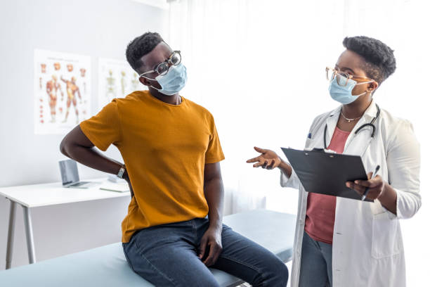 istock Patient telling doctor about his pain in back 1325865446