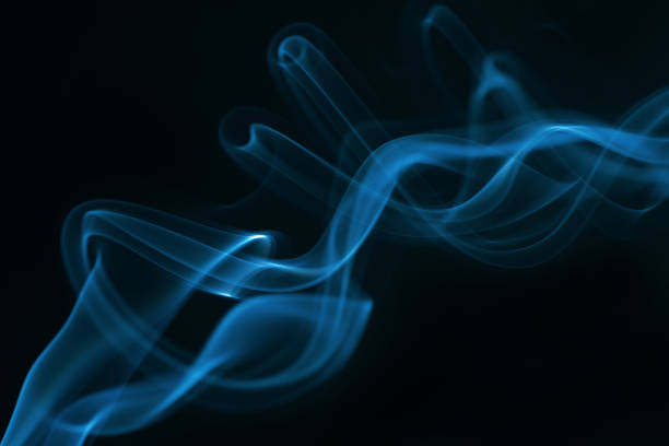 istock Blue smoke isolated on black background. 1325869281