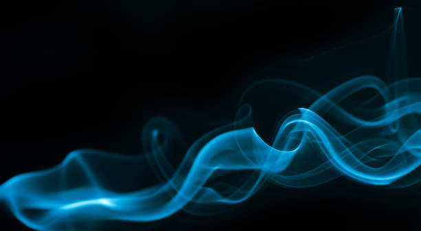 istock Blue smoke isolated on black background. 1325869285