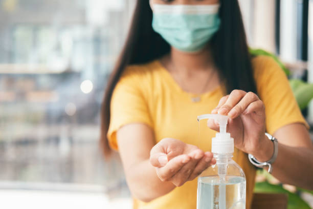 istock Woman hands using hand alcohol gel or sanitizer bottle dispenser 1325871009