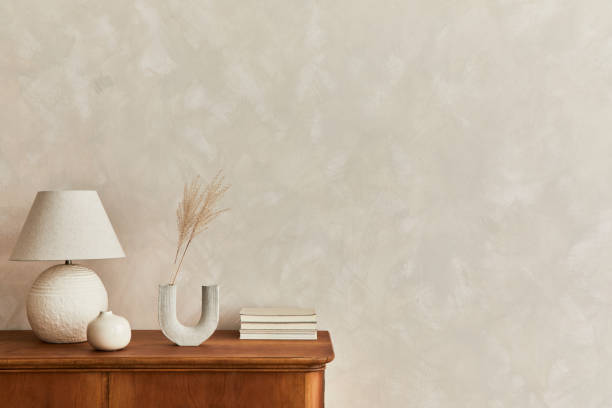 istock Interior design of neutral living room with stylish retro commode and accessories. Template. Copy space. 1325871018