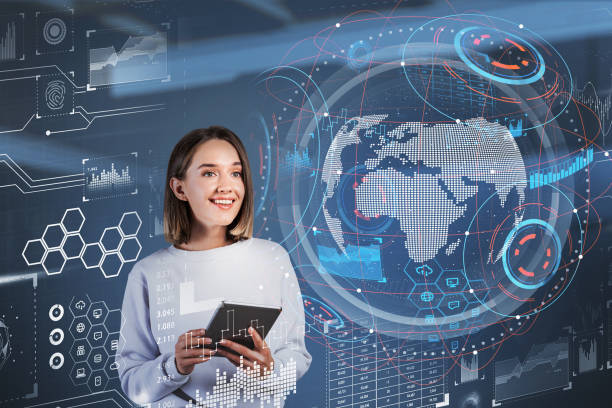 istock Businesswoman smiling using tablet, earth globe hologram with network icons 1325871057