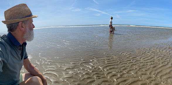 Family at the IJmuiden beach on a warm sunny day