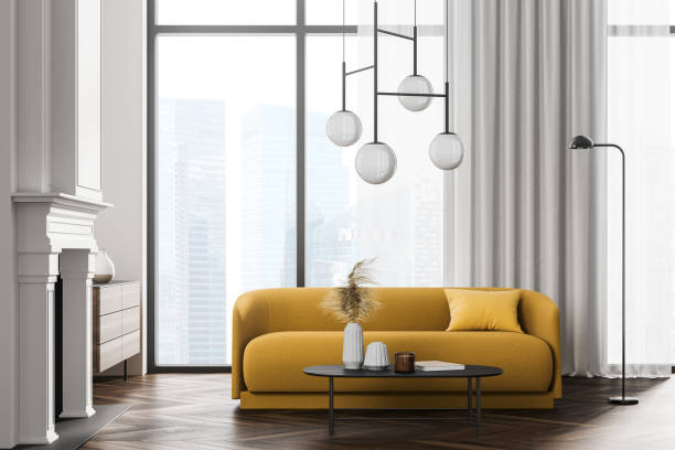 istock White room interior with fireplace and sofa on parquet near window 1325873496