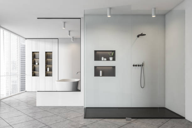 istock Bathroom interior with shower, bathtub with shelf near window 1325873937