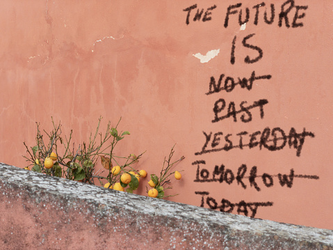 The future is... when? Graffiti on wall with lemons expresses uncertain times. *** The text on the wall was digitally superimposed and a release is provided ***