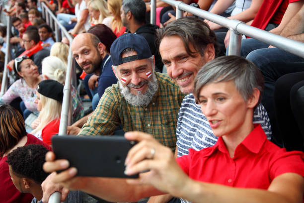 istock People taking a selfies at a footbal match 1325880382