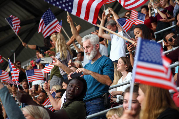 istock Spectators on a stadium with american flags 1325880396
